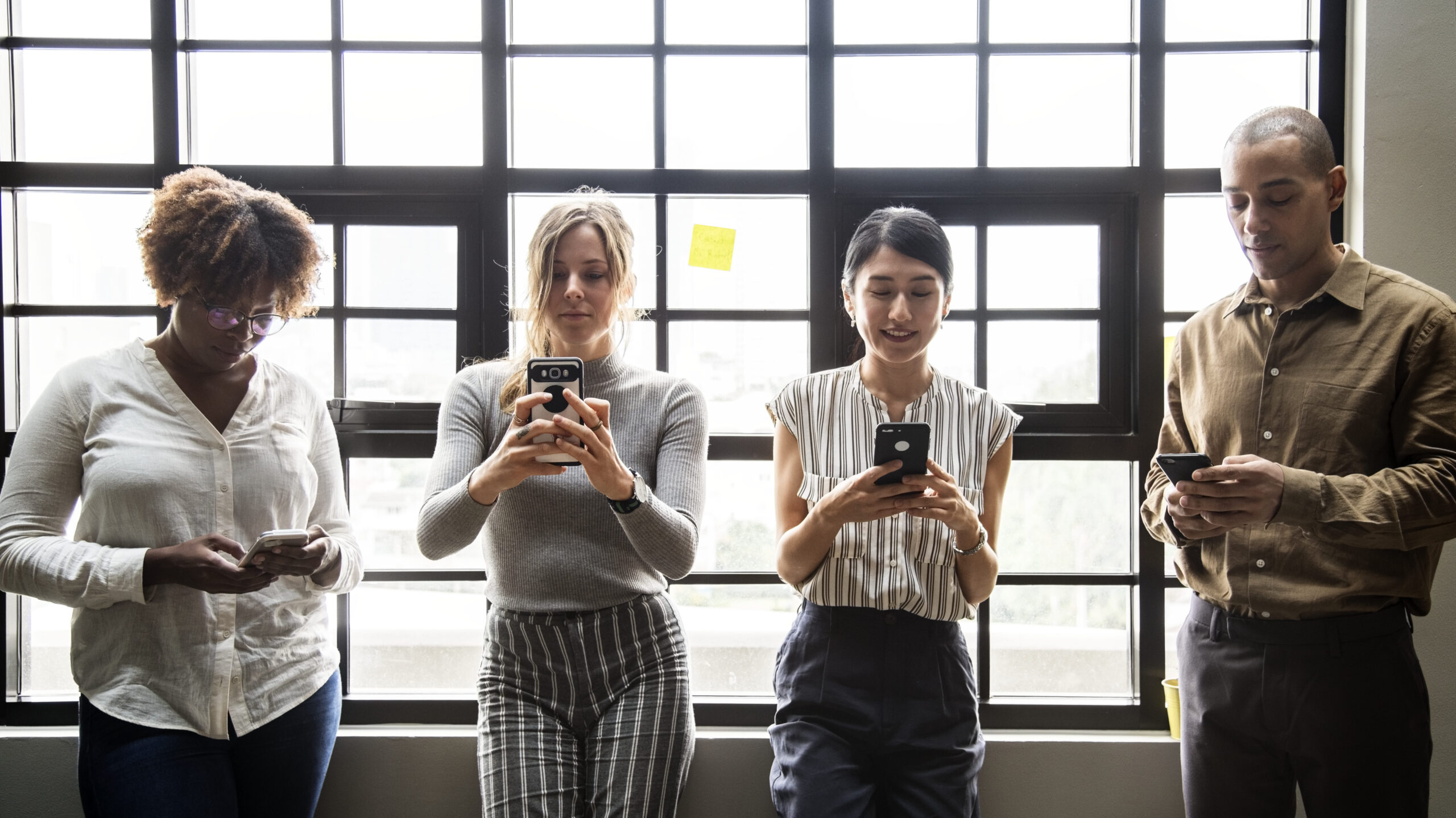 Group of diverse people using smartphones